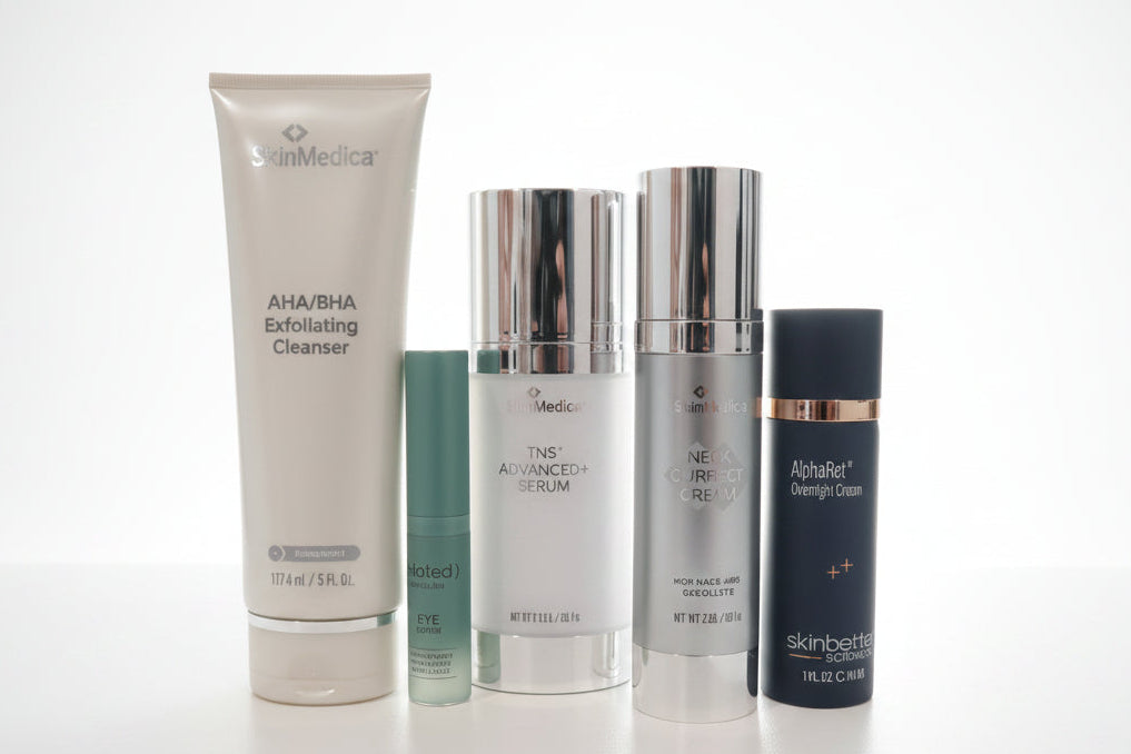 Collection of skincare products on a white surface with a blurred background