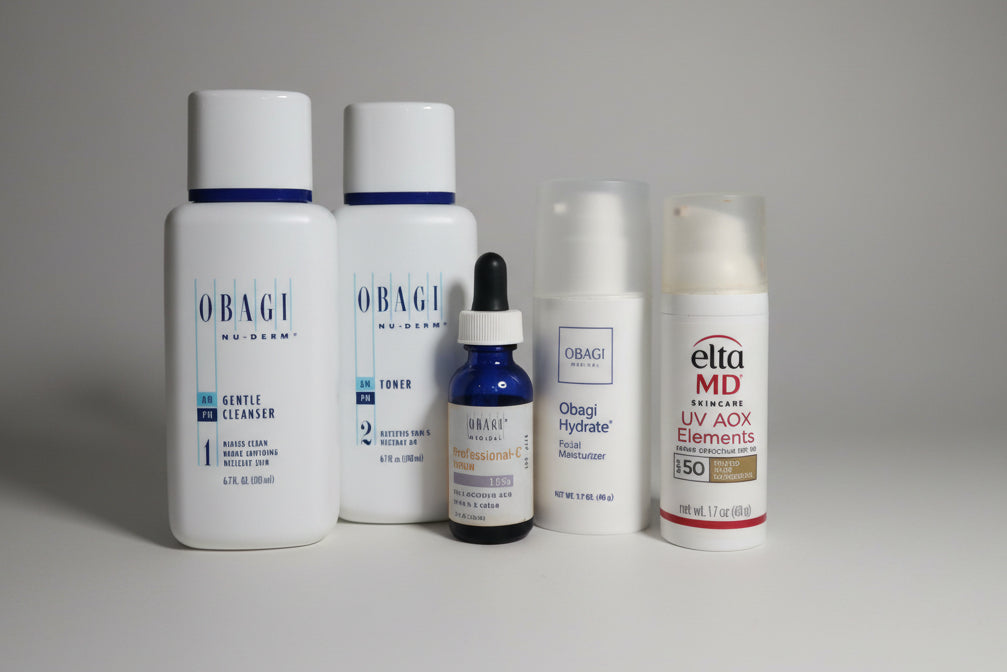 Collection of skincare products including Obagi and Elta MD on a white surface.