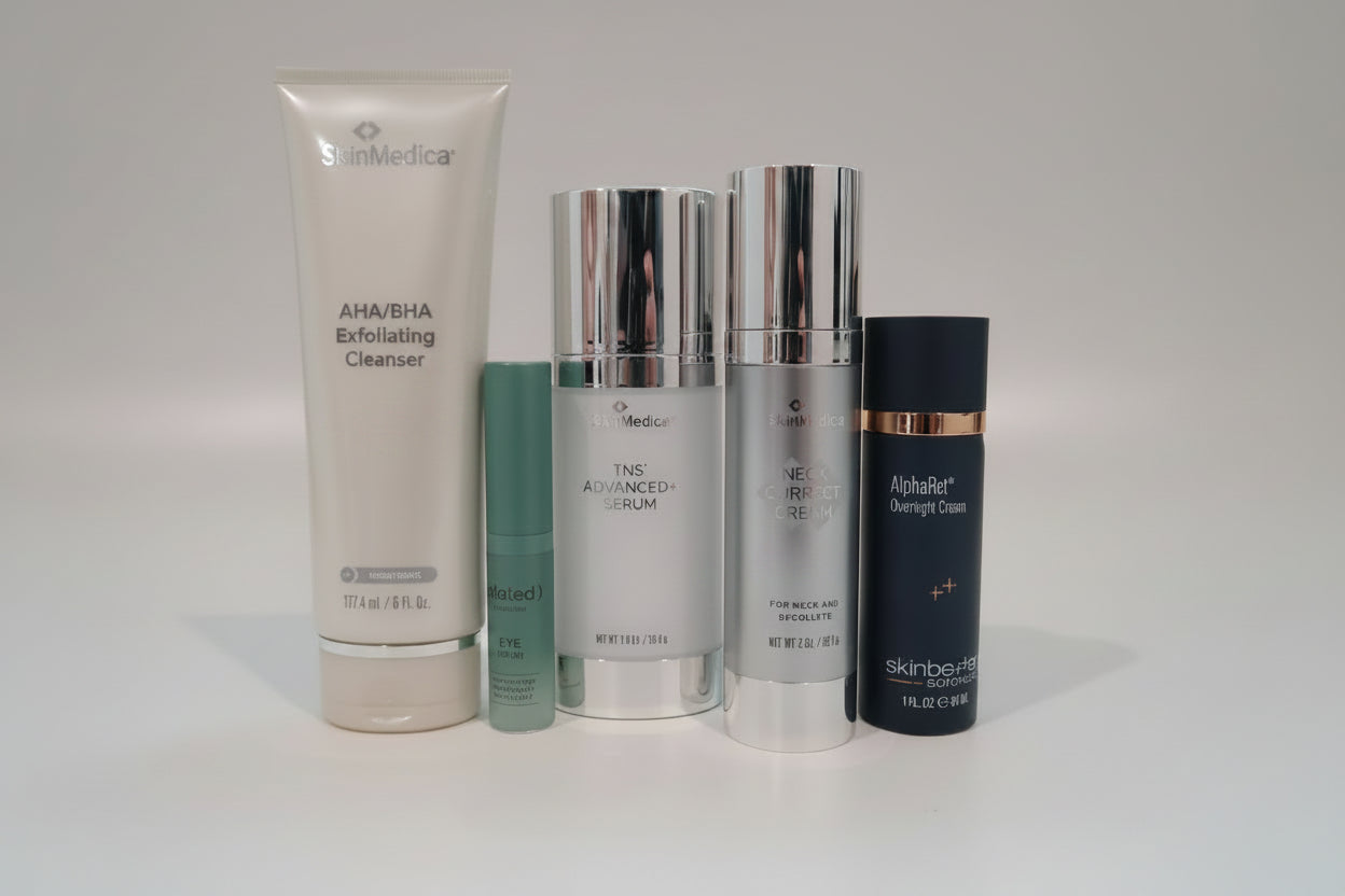 Collection of skincare products on a white surface with a blurred background