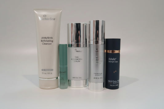 Collection of skincare products on a white surface with a blurred background